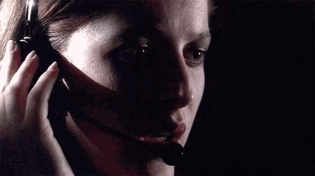 a woman wearing headphones and a microphone with the words mulder it 's me behind her