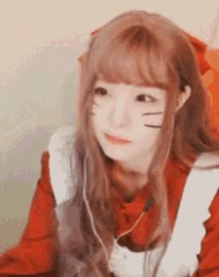 a girl with long hair is wearing headphones and a red apron .