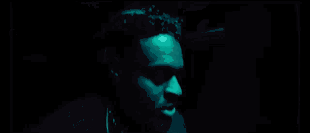 a man in a dark room with headphones on