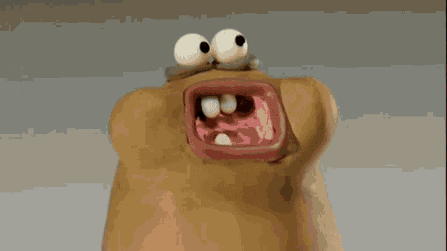 a close up of a cartoon character with a big mouth