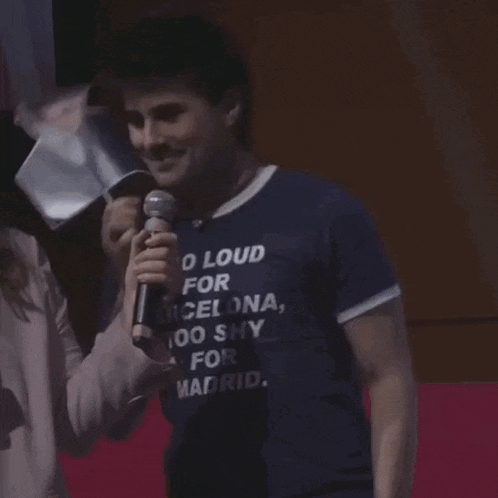 a man wearing a shirt that says " o loud for barcelona "
