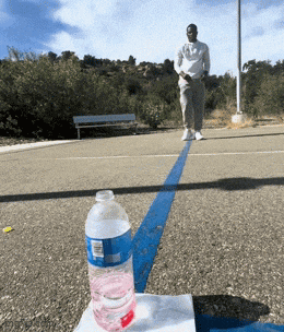 a bottle of water sits on a napkin next to a blue line
