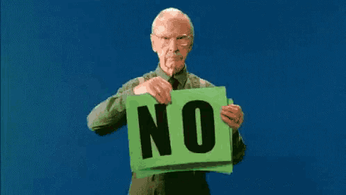 an elderly man is holding a green sign that says " no "