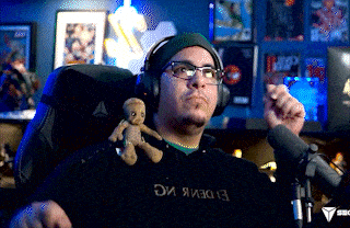 a man wearing headphones and glasses is sitting in a chair holding a card