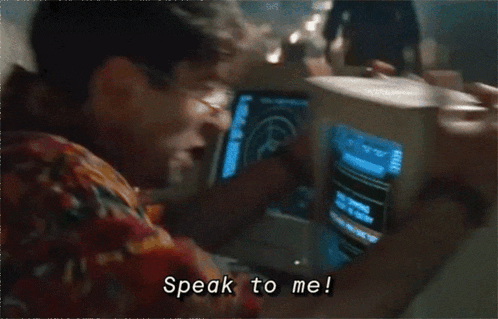 a man says speak to me while looking at a monitor