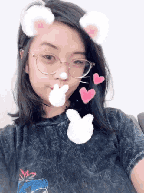 a girl wearing glasses and bunny ears has hearts coming out of her nose