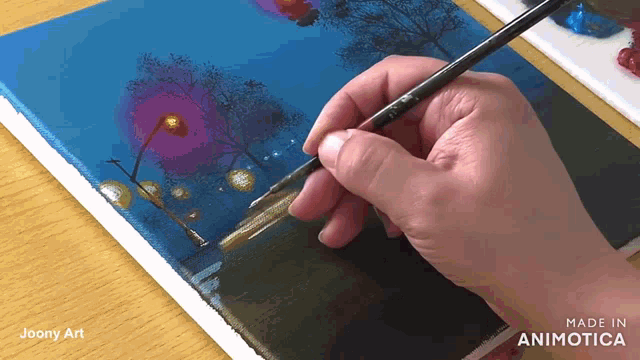 a hand is holding a brush on a canvas that says made in animonica
