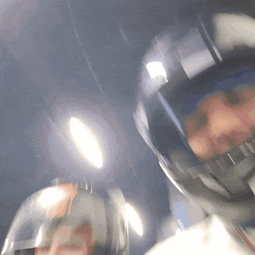 a blurry picture of a person wearing a helmet with a red stripe