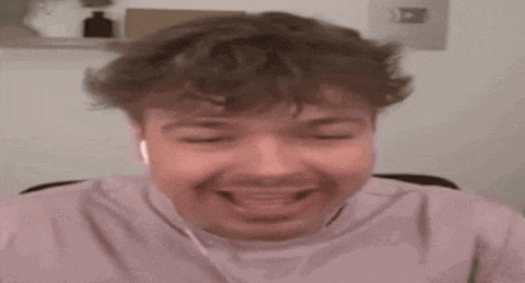 a man is wearing headphones and sticking his tongue out .