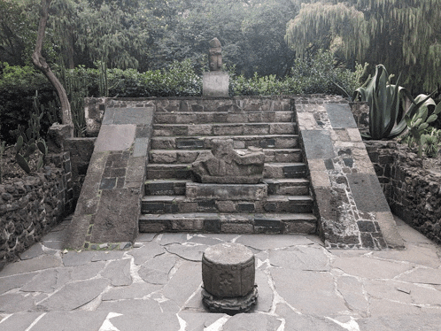 a stone staircase with a statue in the middle