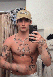 a shirtless man is taking a selfie with his phone