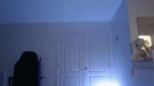 a teddy bear is sitting on a shelf in a room