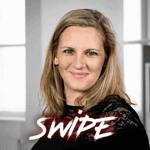 a woman is smiling in front of a sign that says " swipe "