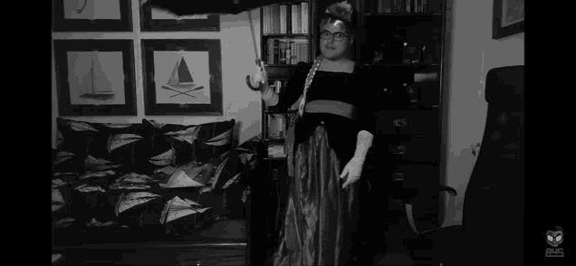 a black and white photo of a woman holding a sword