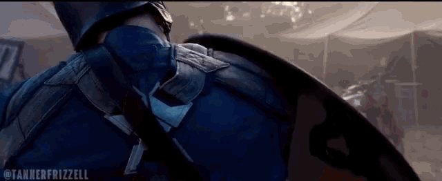 a close up of captain america holding a shield with the hashtag tannerfrizzell at the bottom