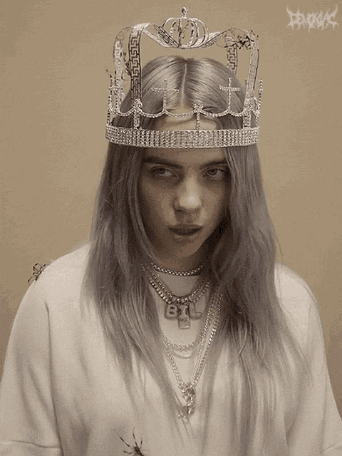 billie eilish wearing a crown and a necklace with the letter b on it