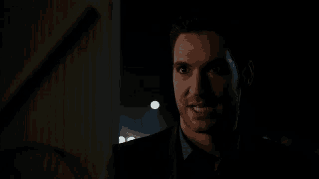 a close up of a demon with red eyes and a triangle on his forehead