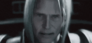 a close up of a man 's face in a black and white photo with long hair .