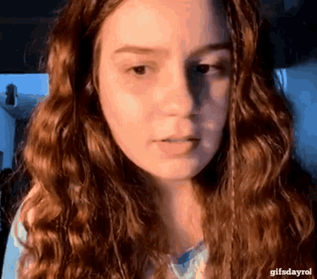a close up of a woman 's face with the words gifsdayrol in the corner