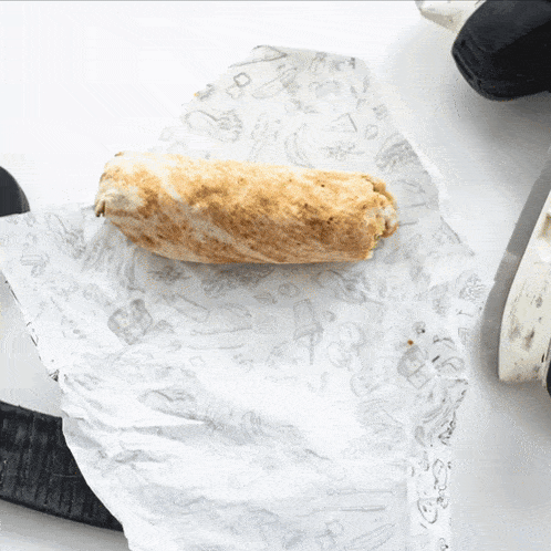 a burrito is sitting on a piece of paper that says ' ice cream '