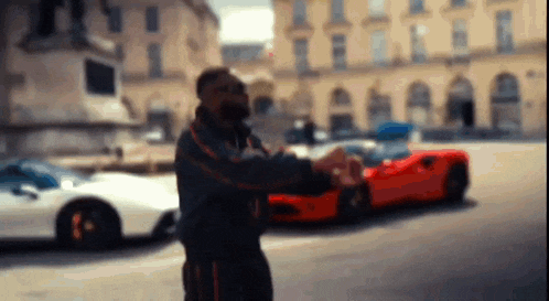 a man standing in front of a row of cars