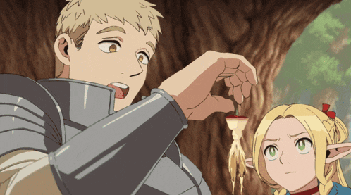 a man and a girl are standing next to each other and the man is holding something in his hand