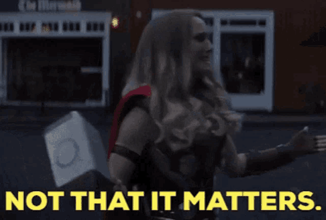 a woman in a superhero costume is holding a hammer and says not that it matters