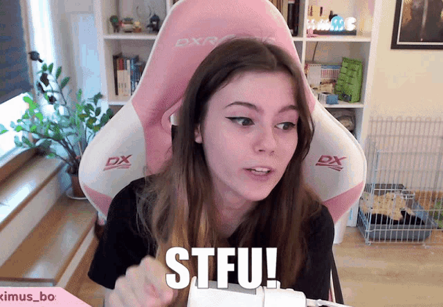 a girl is sitting in a pink and white dxr chair