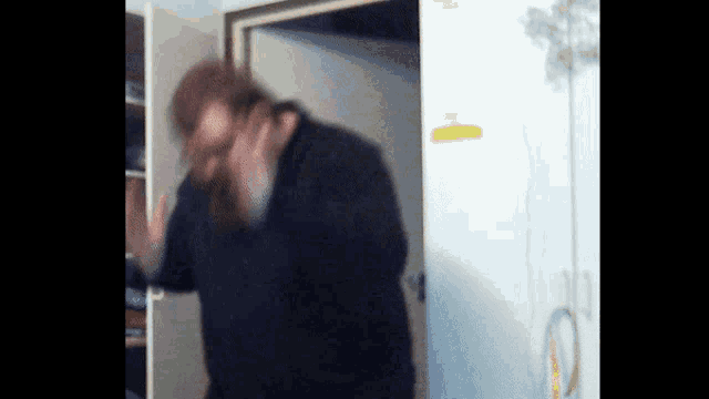 a blurry picture of a man standing in a room