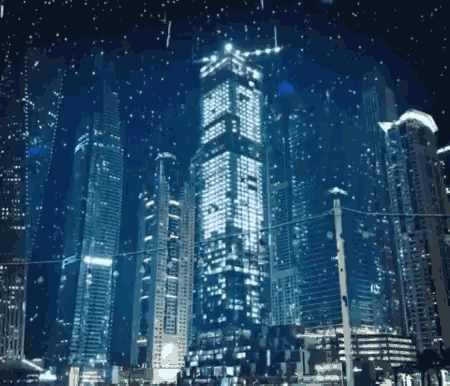 a city at night with a very tall building that says ' a ' on it