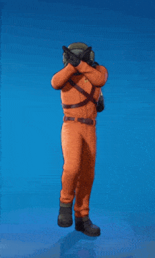 a man in an orange jumpsuit is dancing with a helmet and gas tanks on his back