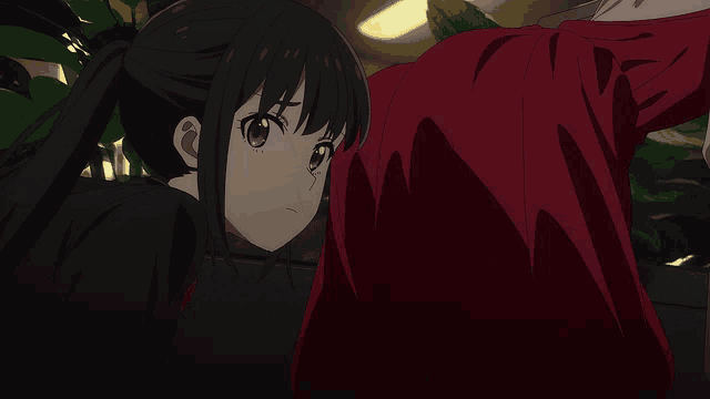 a girl with a ponytail and a red shirt looks at a man in a red shirt