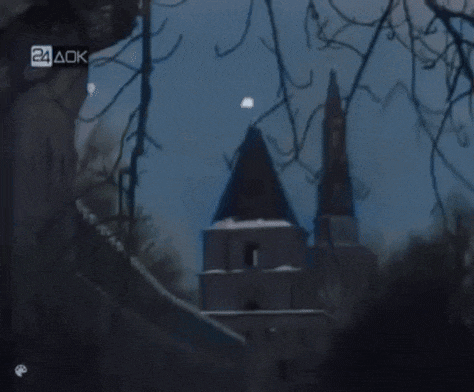 a blurred image of a church with a 24 aok logo