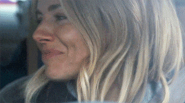 a close up of a woman 's face with long blonde hair .