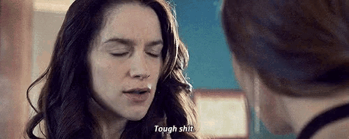 a woman is talking to another woman in a room and says `` tough shit '' .