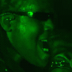 a man wearing sunglasses is visible in a green background