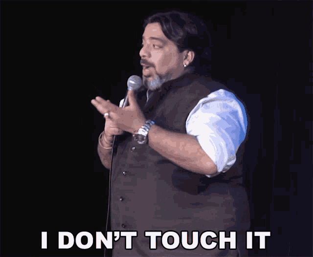 a man stands in front of a microphone and says i don t touch it