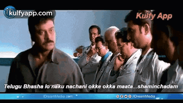 a group of doctors are standing in a line and one of them is talking to another