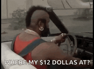 a man is driving a car with the words `` where my $ 12 dollars at '' written on the screen .