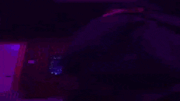 a dark room with a blue light coming out of the corner