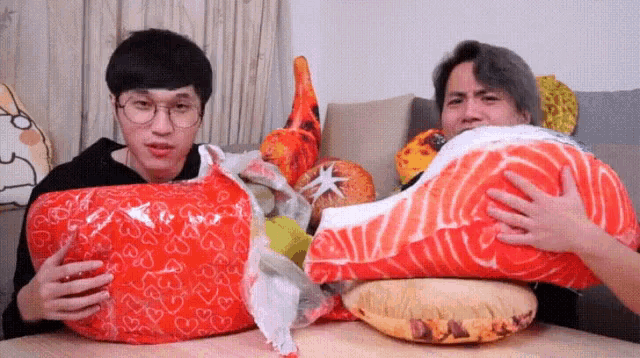a man is holding a pillow that looks like a piece of meat