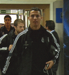 a man in a black adidas jacket with the number 7 on the back