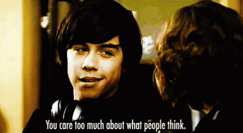 a man with headphones is talking to another man with the words " you care too much about what people think "