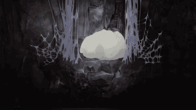 a cartoon character is sitting in a cave surrounded by webs