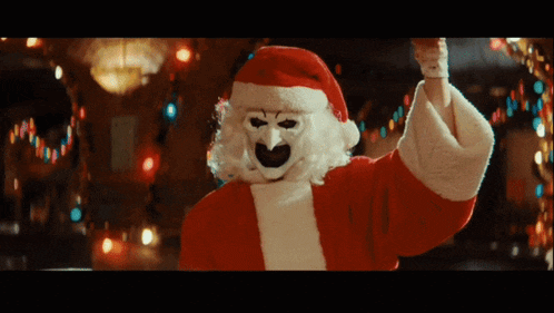 a person dressed as santa claus with a white mask on