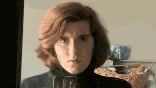 a woman with red hair is taking a selfie