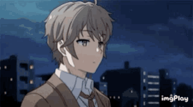a young boy in a suit and tie is standing in front of a city skyline .