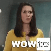 a woman in a yellow cardigan is making a surprised face and says wow .