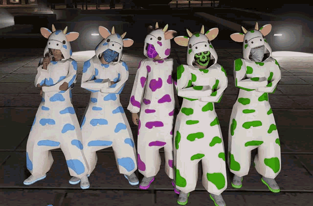 a group of people wearing cow costumes are standing next to each other with their arms crossed