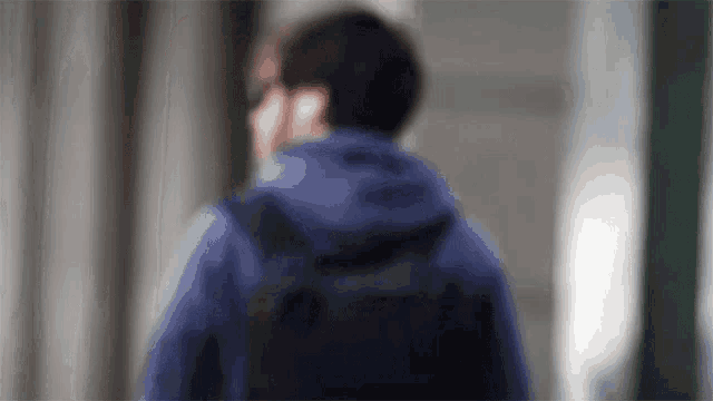 a blurry picture of a man with a backpack